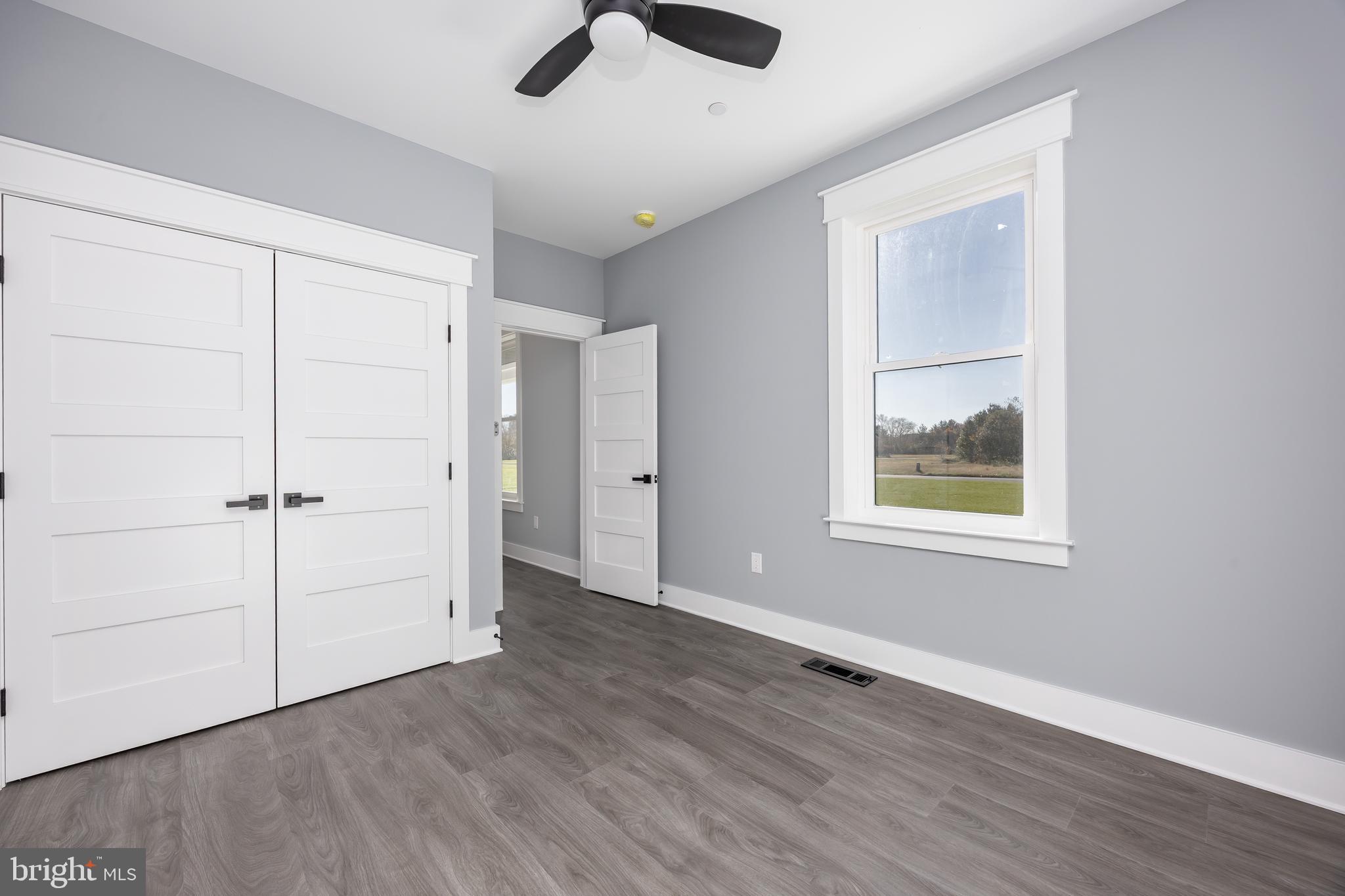 5692 King Stuart Drive Salisbury, MD 21801 - Photo 36 of 82 an empty room with wooden floor cabinet and windows