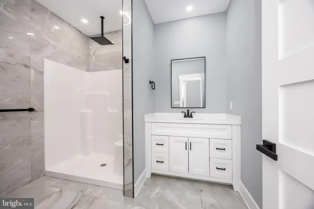 a bathroom with a granite countertop sink a toilet and a bathtub