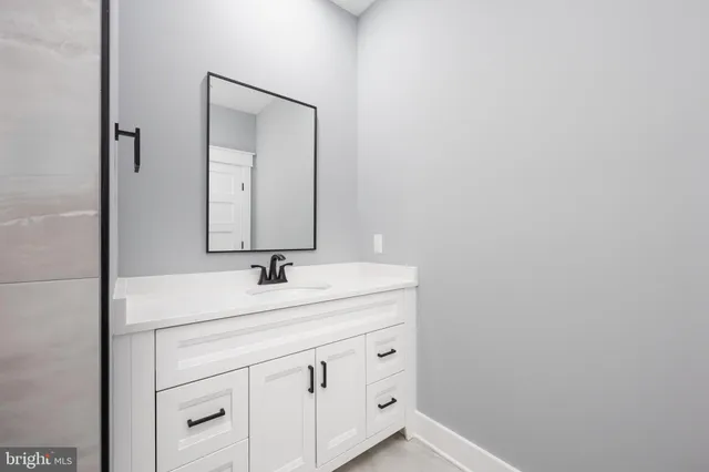 a bathroom with a toilet a sink a vanity and mirror