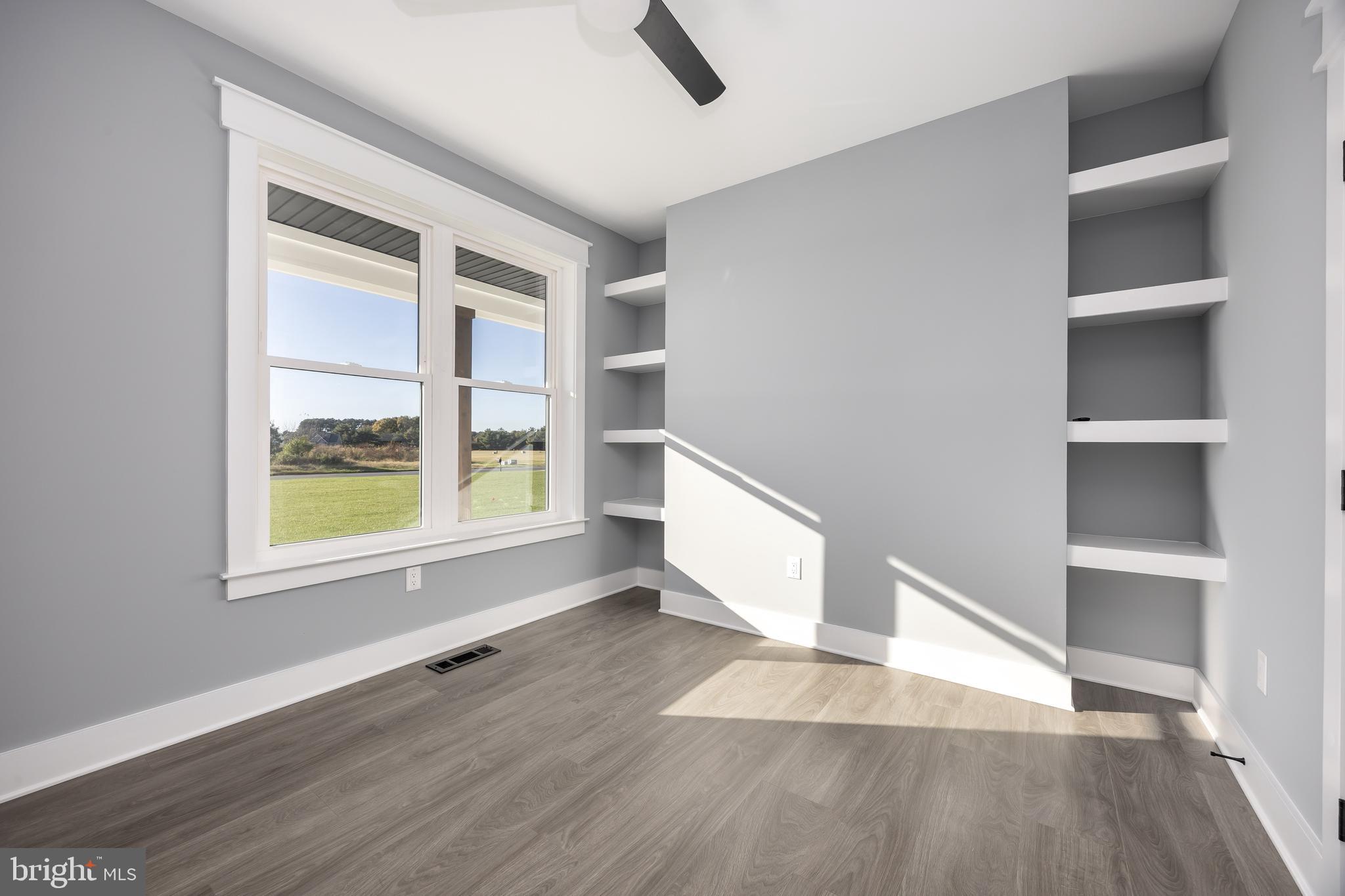 5692 King Stuart Drive Salisbury, MD 21801 - Photo 57 of 82 an empty room with wooden floor and windows