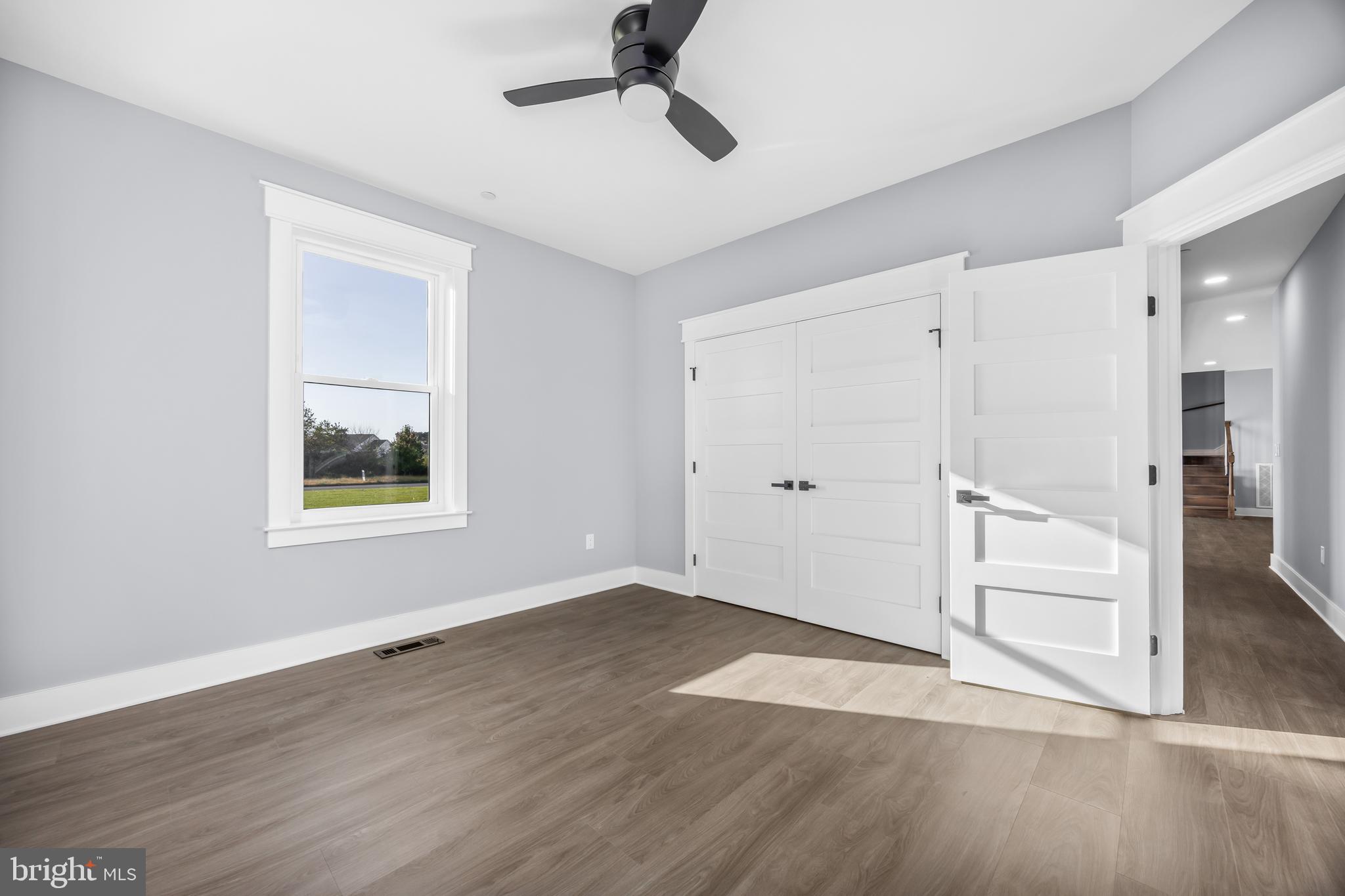 5692 King Stuart Drive Salisbury, MD 21801 - Photo 62 of 82 a view of an empty room with wooden floor and a window