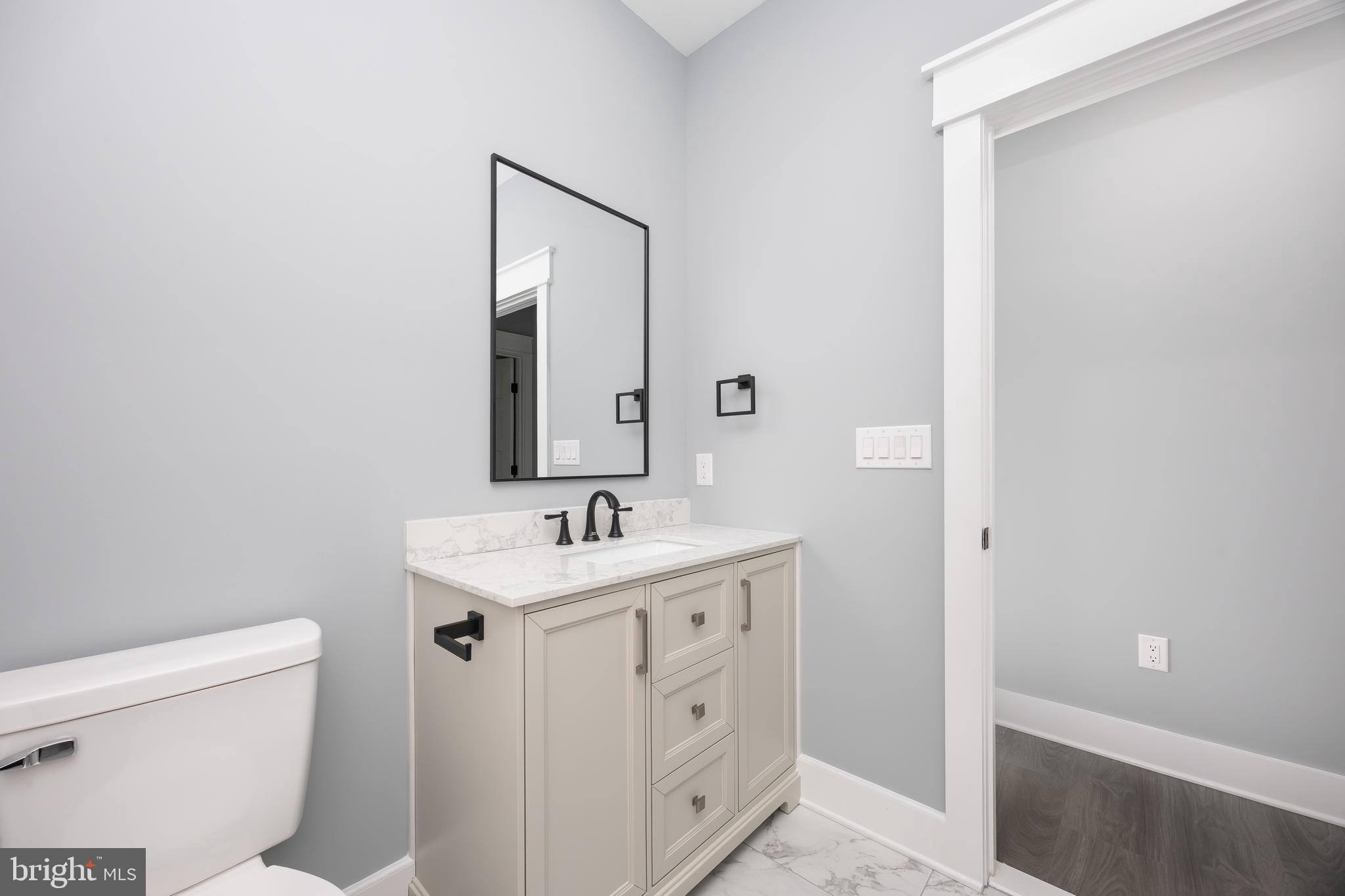 5692 King Stuart Drive Salisbury, MD 21801 - Photo 65 of 82 a bathroom with a toilet a sink a vanity and mirror