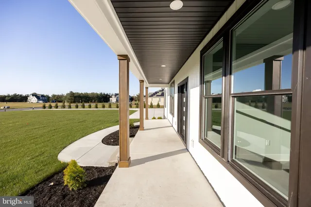 a living room with furniture and a kitchen view