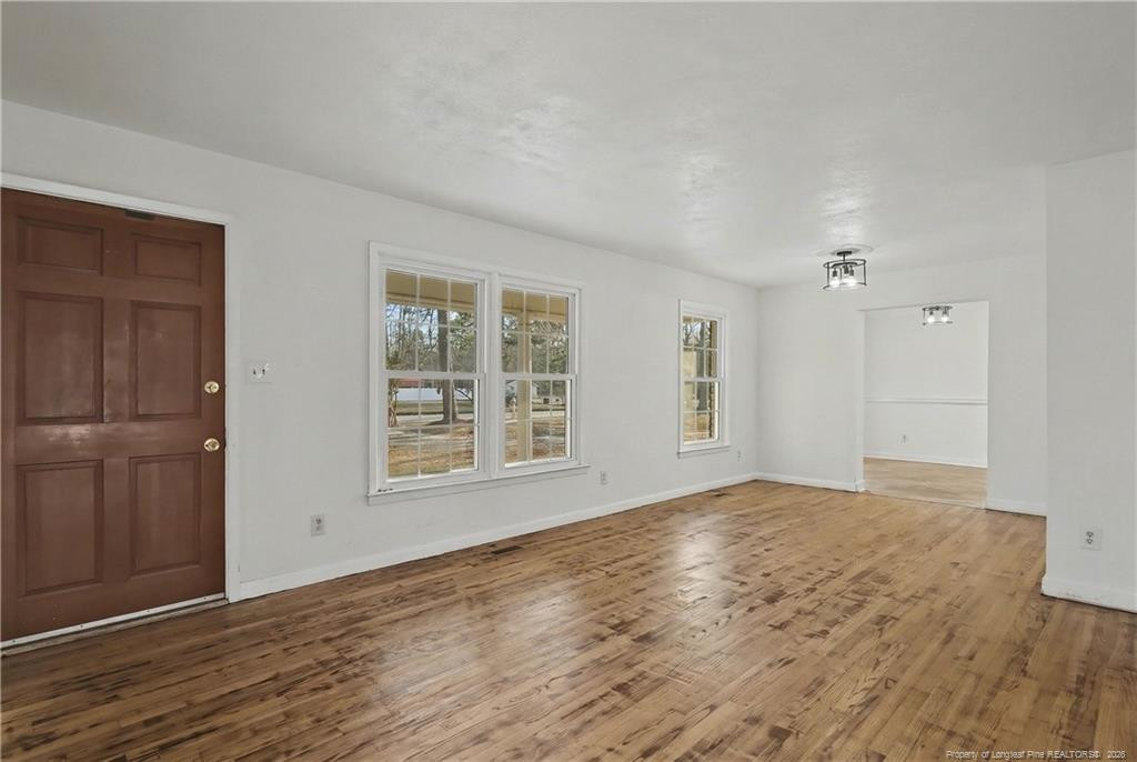 347 Forest Road Lumberton, NC 28358 - Photo 13 of 45 a view of an empty room with wooden floor and a window