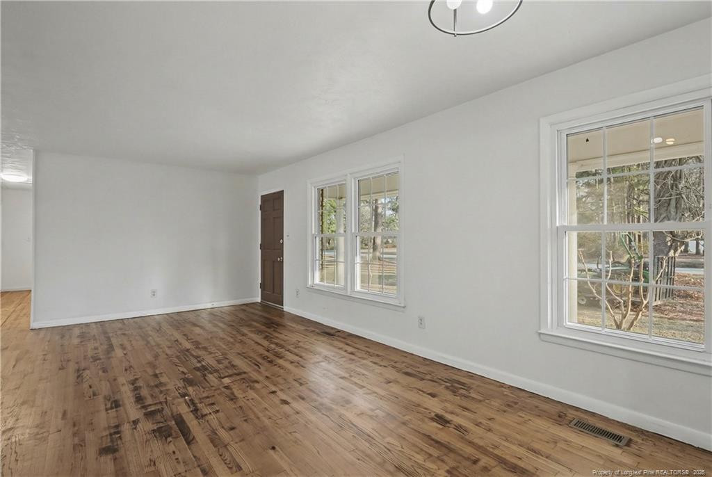 347 Forest Road Lumberton, NC 28358 - Photo 14 of 45 a view of an empty room with wooden floor and a window