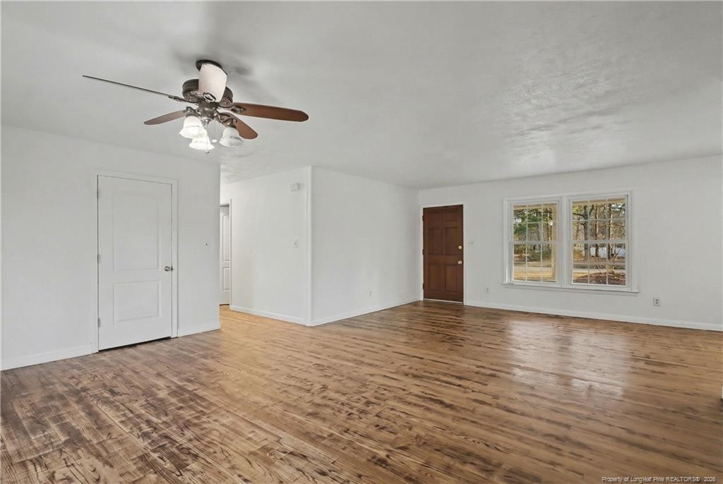 347 Forest Road Lumberton, NC 28358 - Photo 16 of 45 a view of empty room with wooden floor and ceiling fan