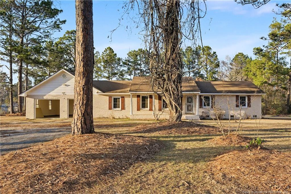 347 Forest Road Lumberton, NC 28358 - Photo 3 of 45 a front view of a house with a garden