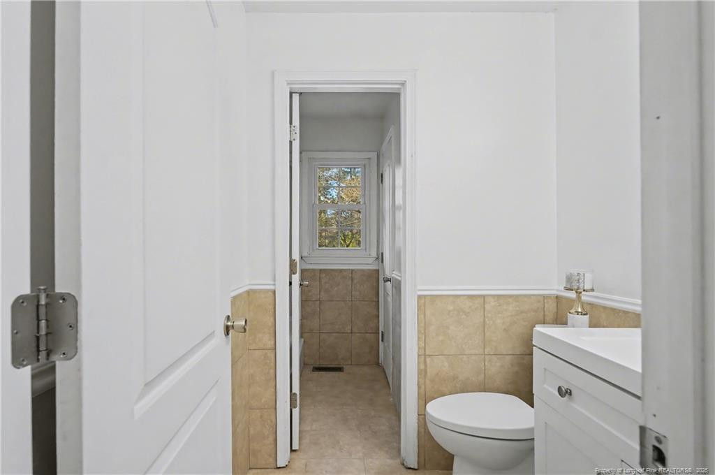 347 Forest Road Lumberton, NC 28358 - Photo 36 of 45 a bathroom with a toilet a sink and mirror