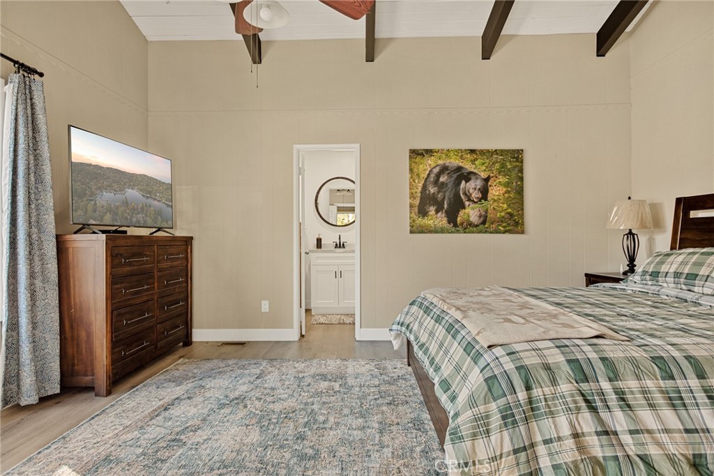 30789 All View Drive Running Springs, CA 92382 - Photo 13 of 25 a bedroom with a bed and a chandelier