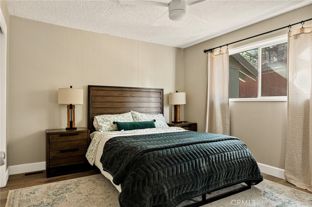 30789 All View Drive Running Springs, CA 92382 - Photo 17 of 25 a bedroom with a bed and wooden floor