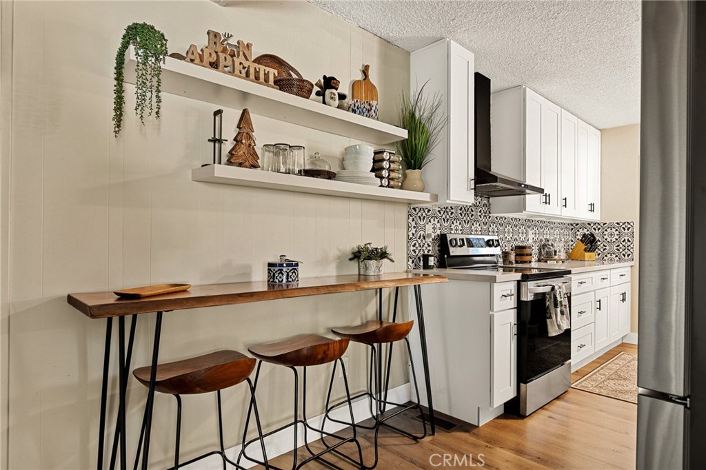 30789 All View Drive Running Springs, CA 92382 - Photo 6 of 25 a kitchen with stainless steel appliances granite countertop a sink and cabinets
