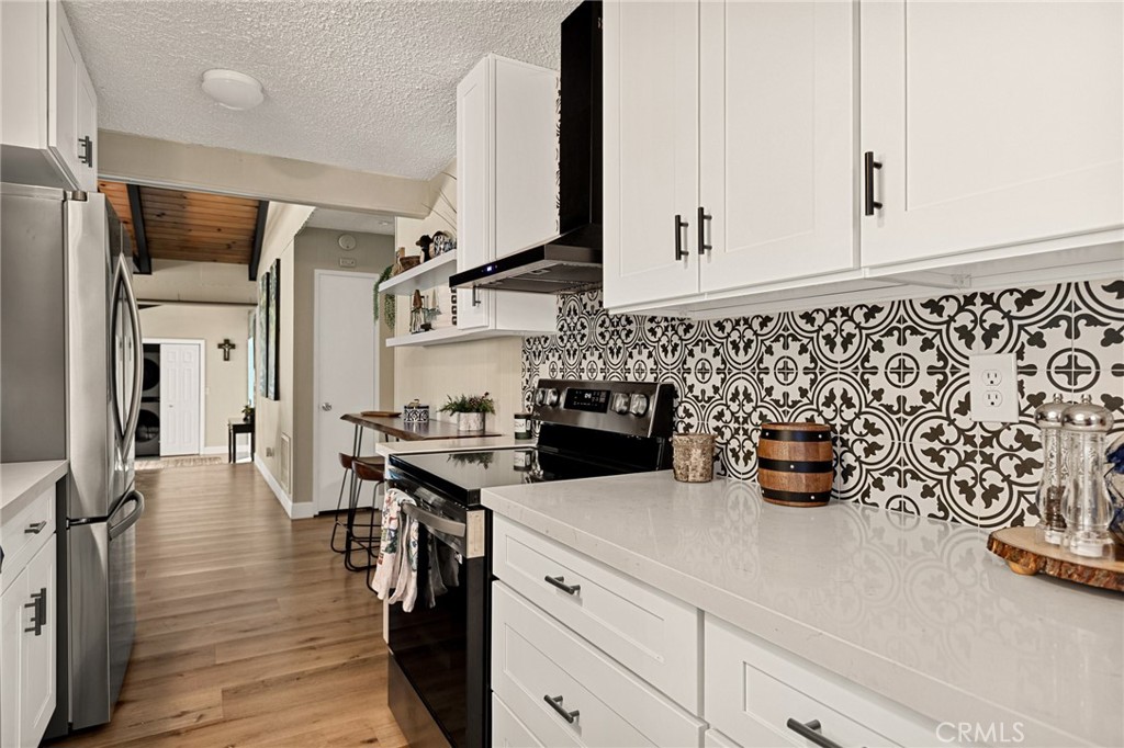 30789 All View Drive Running Springs, CA 92382 - Photo 9 of 25 a kitchen with stainless steel appliances a sink and cabinets