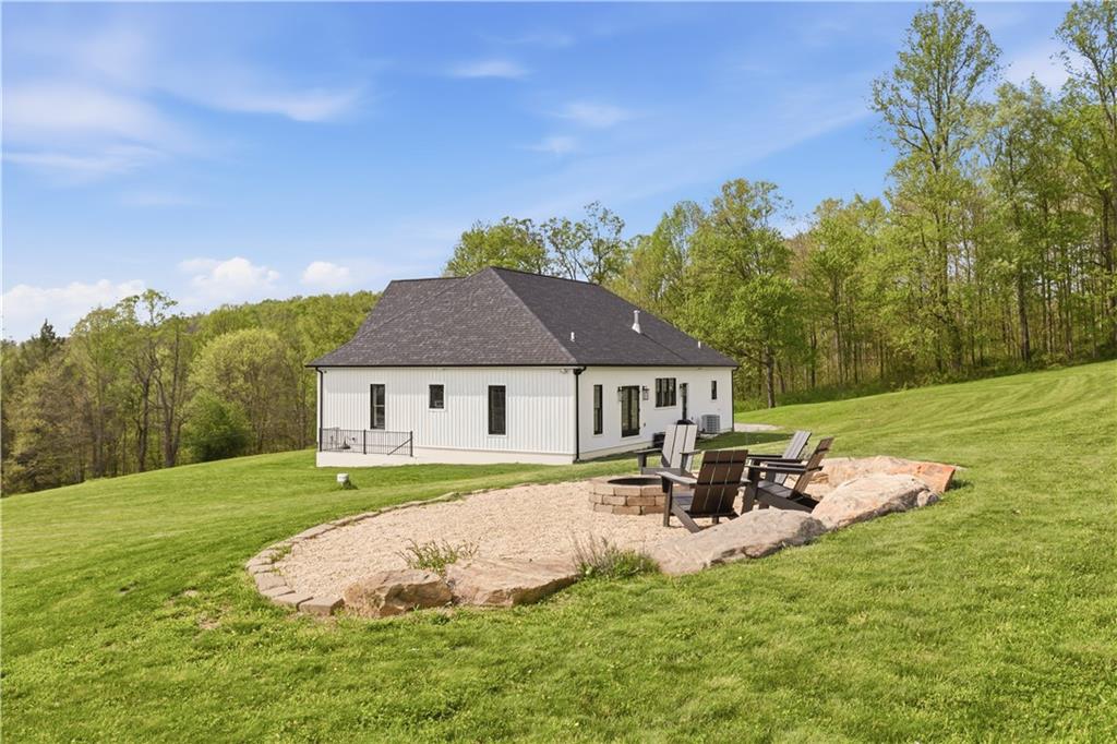 315 Stewarton Road Mill Run, PA 15464 - Photo 41 of 47 a view of a house with a yard porch and sitting area