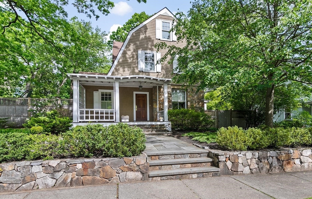 front view of a house with a bench