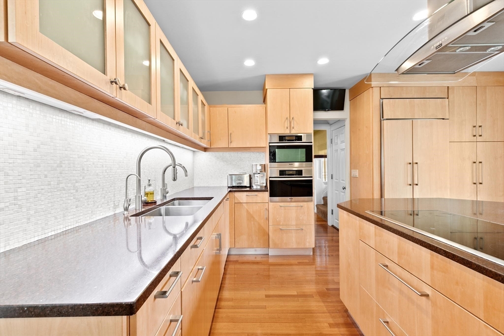 26 Saxon Road Newton, MA 02461 - Photo 5 of 25 a kitchen with stainless steel appliances a sink and cabinets
