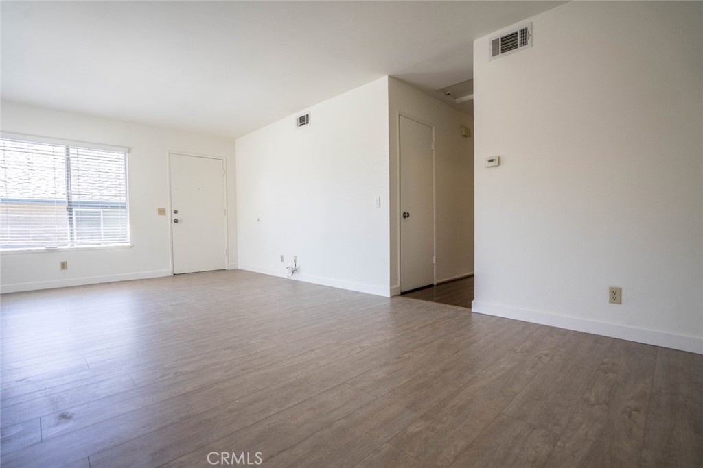 731 Windwood Drive Walnut, CA 91789 - Photo 12 of 15 an empty room with wooden floor and windows