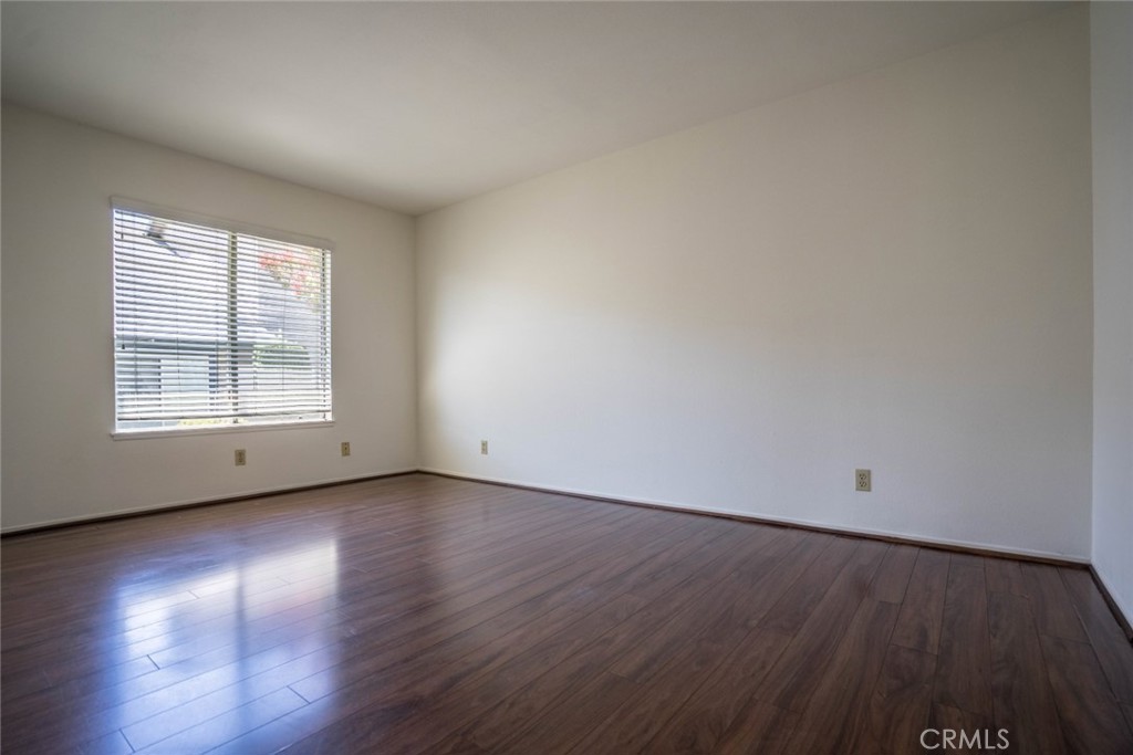 731 Windwood Drive Walnut, CA 91789 - Photo 7 of 15 an empty room with wooden floor and windows