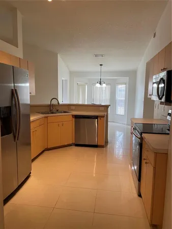 a large kitchen with cabinets and stainless steel appliances