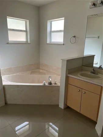 a bathroom with a bathtub and a sink