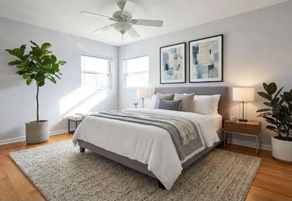 a bedroom with a bed potted plant and a window