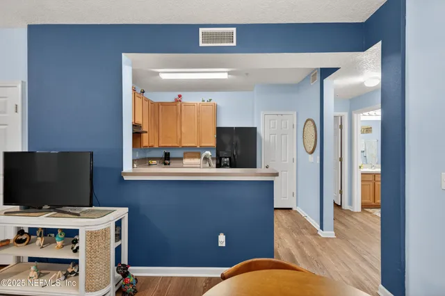 a view of a livingroom with workspace and a window