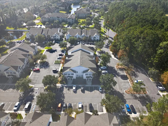 an aerial view of multiple houses with yard