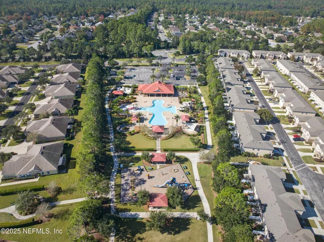 an aerial view of a house with a yard