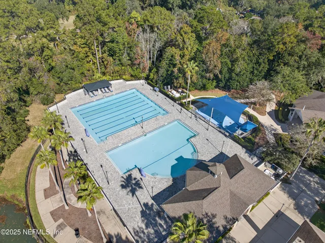an aerial view of a residential houses with outdoor space