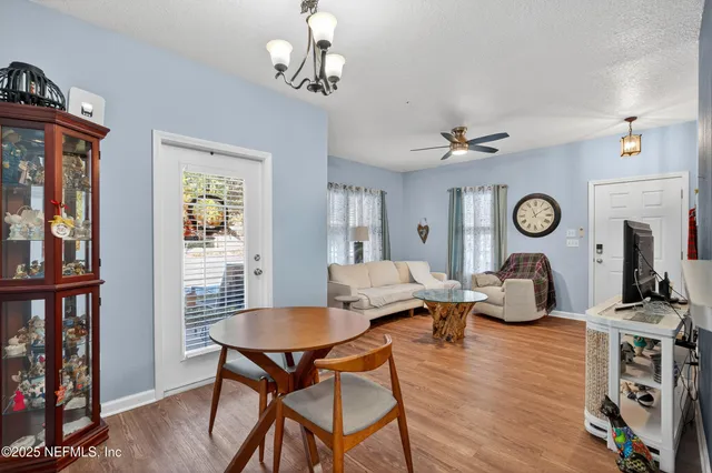 a living room with furniture a rug and a window