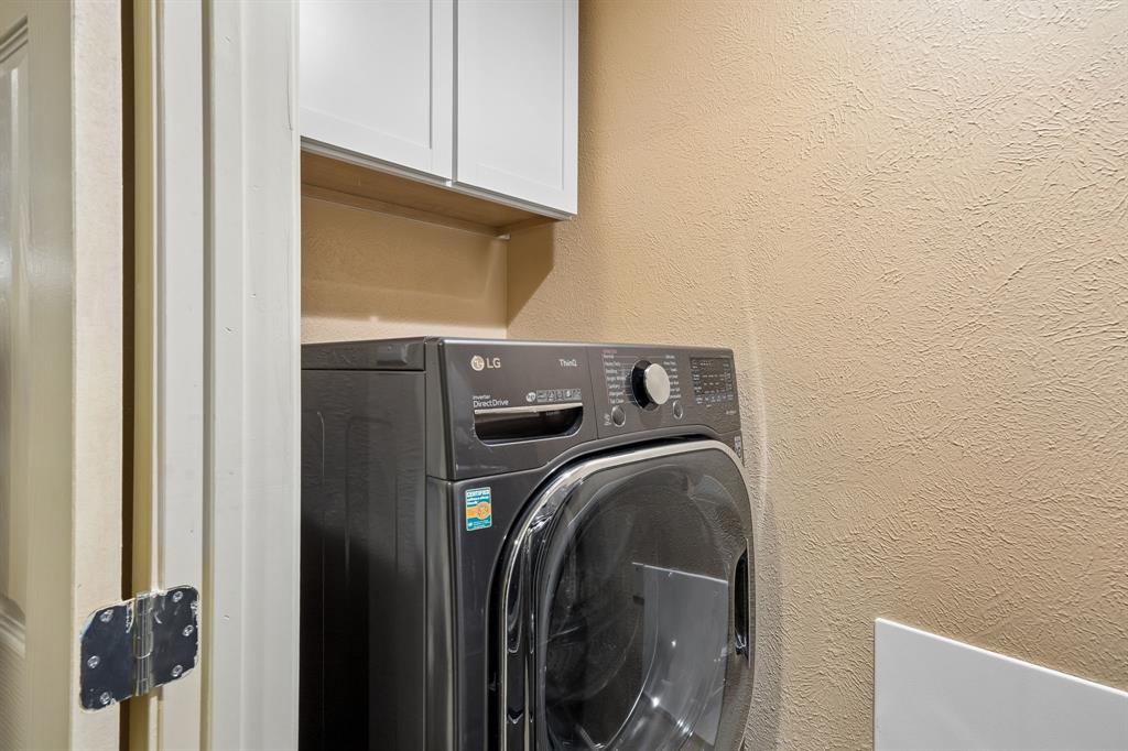 2617 Quail Ridge Irving, TX 75060 - Photo 15 of 17 Built-in laundry appliances with overhead white shaker cabinetry