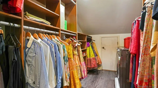 a view of walk in closet with clothes and shoes