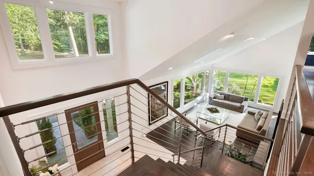 a view of an entryway with wooden floor and windows