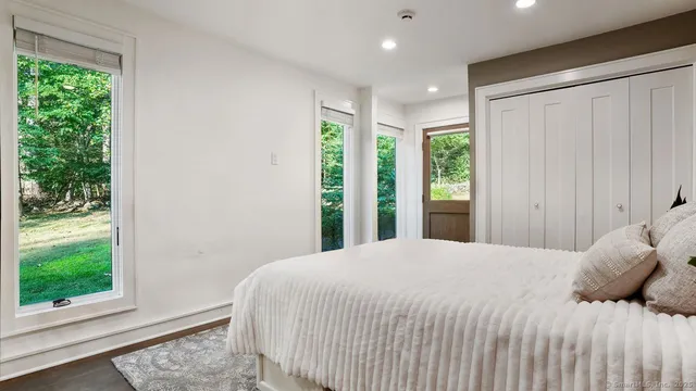 a bedroom with a large window and a bed