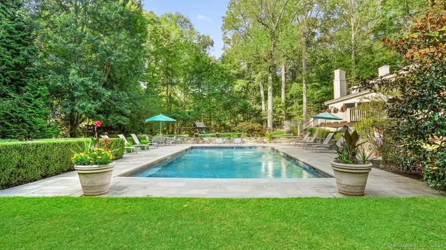 a view of a backyard with swimming pool