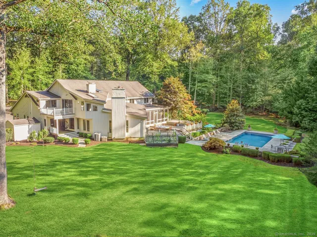 a aerial view of a house with a yard table and chairs