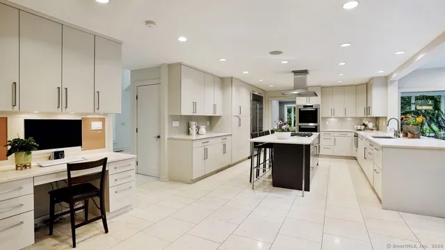 a kitchen with a refrigerator and a stove top oven