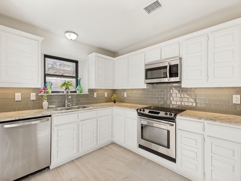 4010 Rive Lane Addison, TX 75001 - Photo 6 of 25 a kitchen with white cabinets appliances and a sink