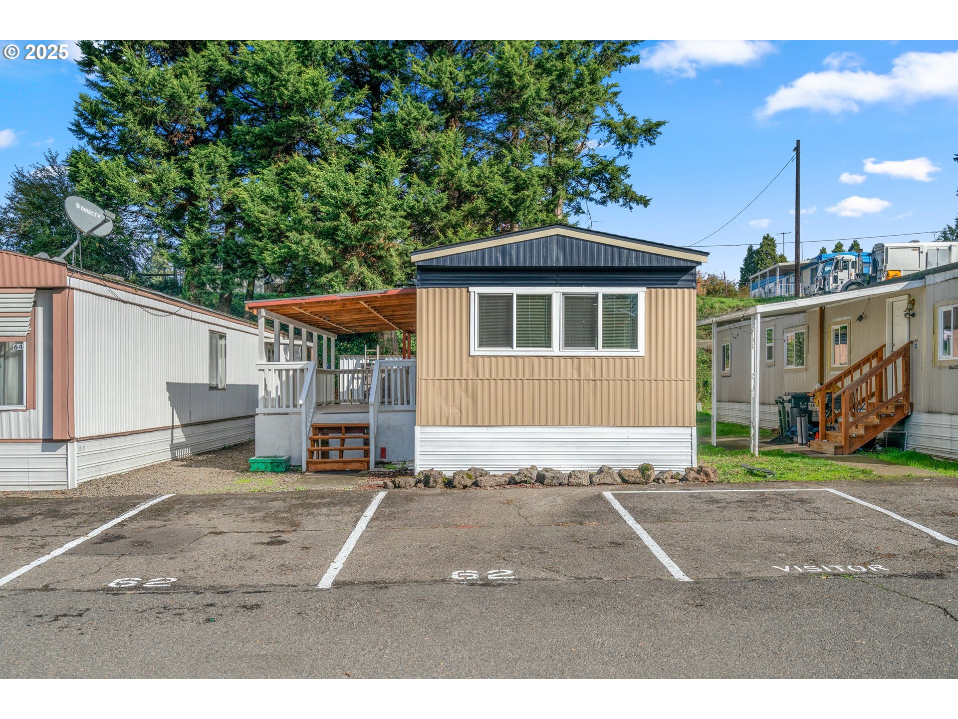 a view of a yard in front of a house with a patio
