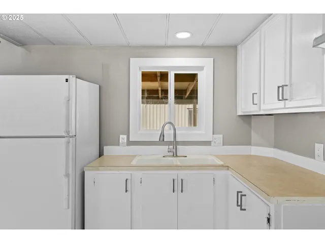 a kitchen with a sink and cabinets