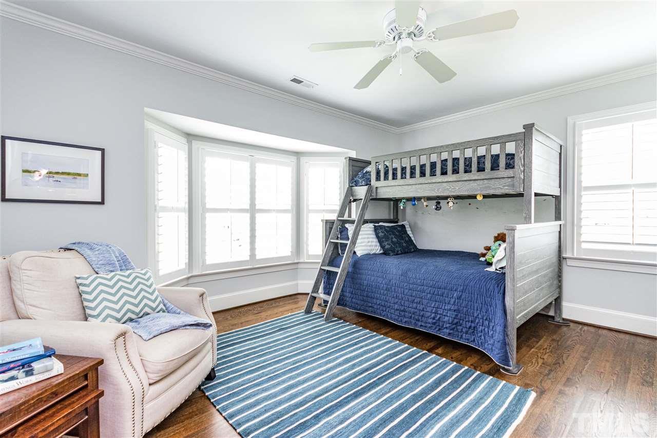 1328 Duplin Road Raleigh, NC 27607 - Photo 22 of 30 a bedroom with a bed and wooden floor