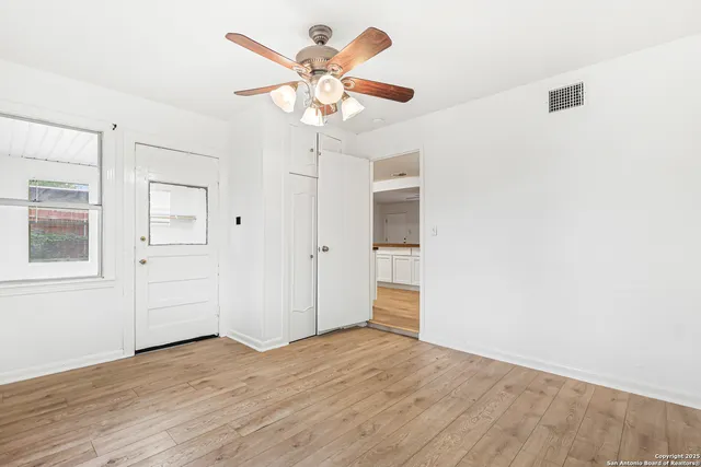 wooden floor in an empty room with a window