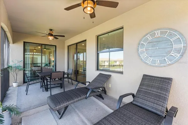 a spacious bedroom with a bed and glass windows