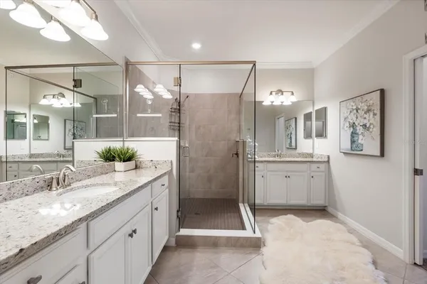 a bathroom with a granite countertop toilet a sink and a mirror