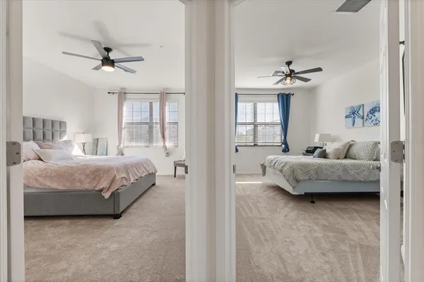 a spacious bedroom with a bed and a chandelier