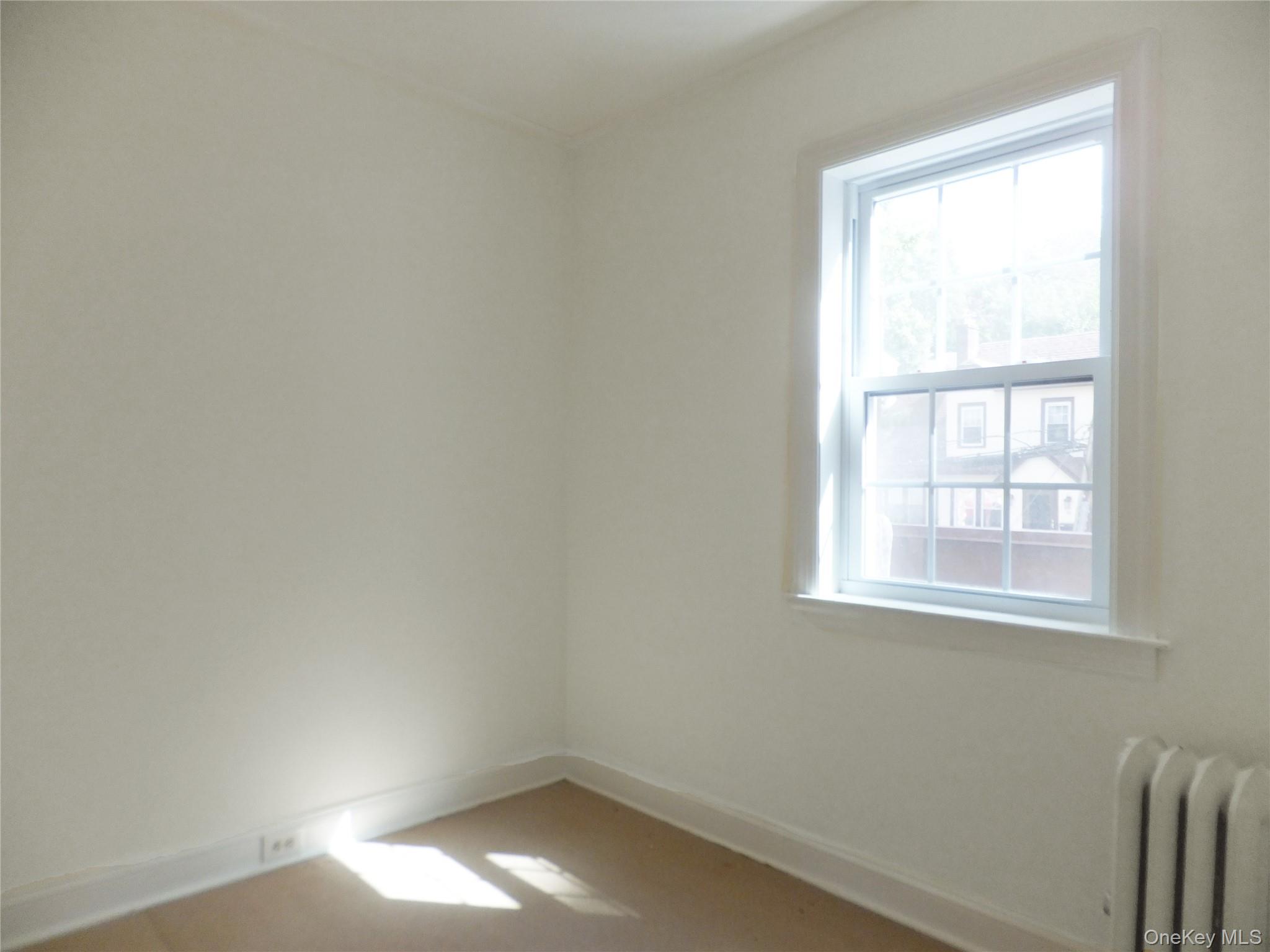107 Kensington Road, Unit 5 Bronxville, NY 10708 - Photo 10 of 17 Spare room featuring radiator and baseboards