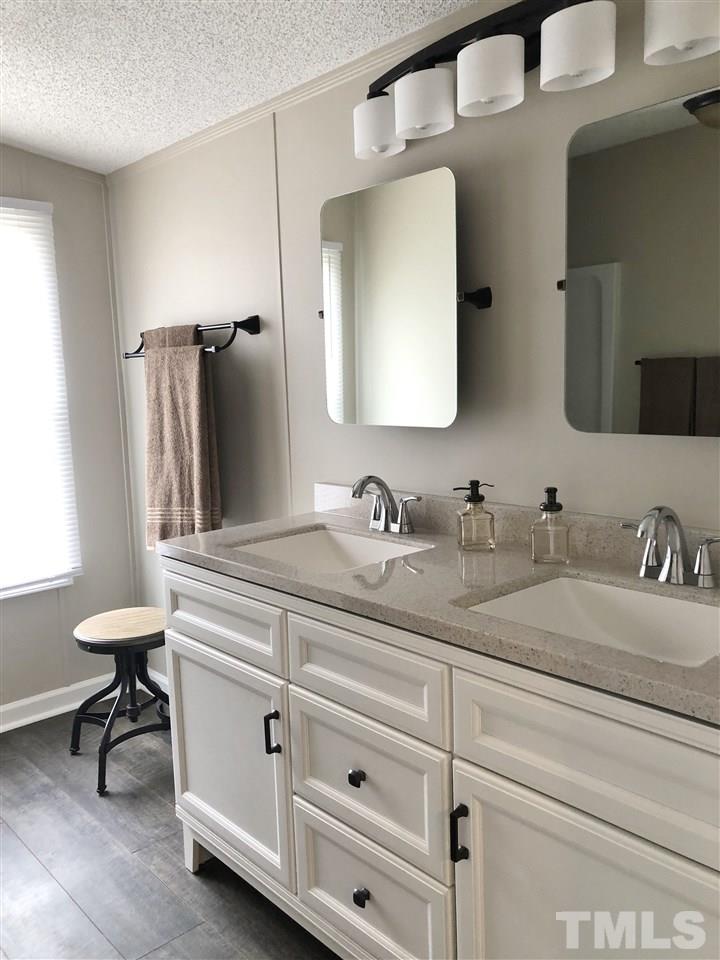 238 Dustin Lane Roxboro, NC 27574 - Photo 14 of 23 a bathroom with a sink vanity and a mirror