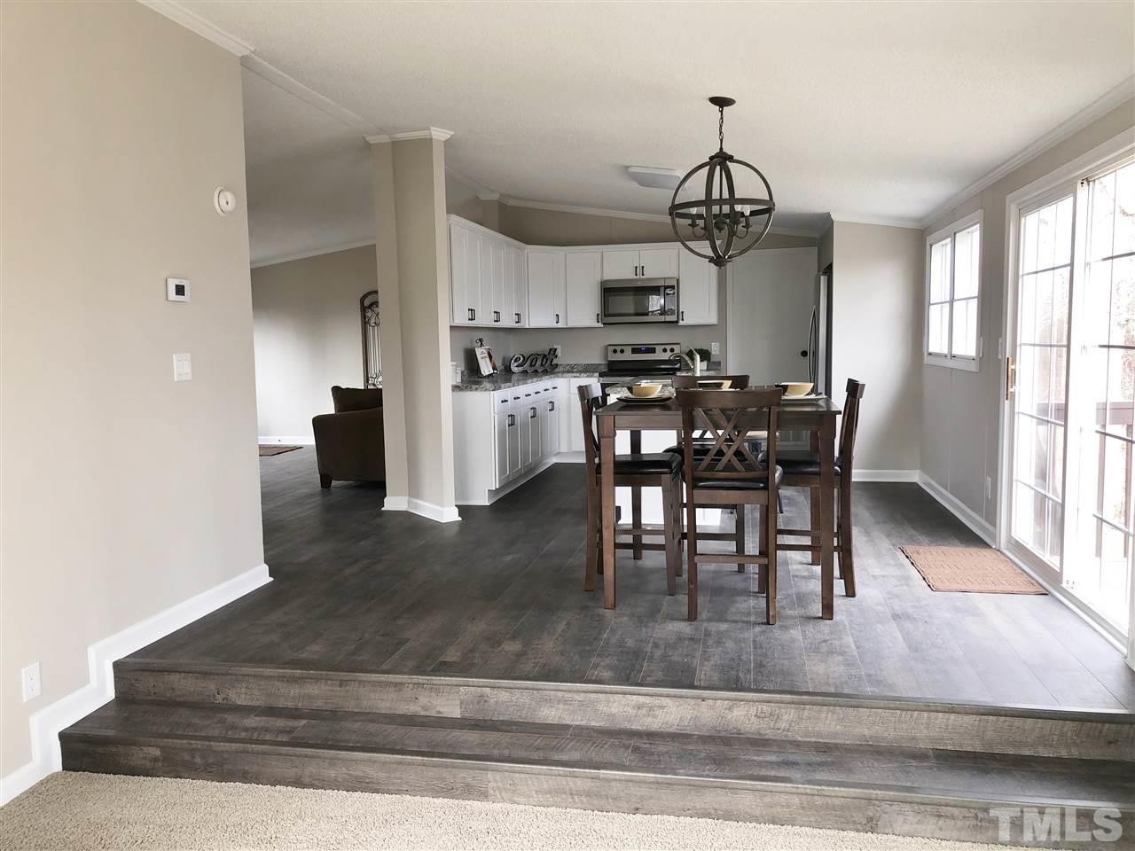 238 Dustin Lane Roxboro, NC 27574 - Photo 3 of 23 a view of a dining room with furniture window and wooden floor