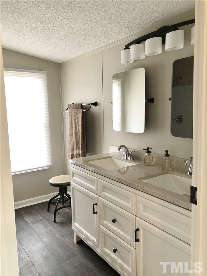 238 Dustin Lane Roxboro, NC 27574 - Photo 6 of 23 a bathroom with a granite countertop sink and a mirror