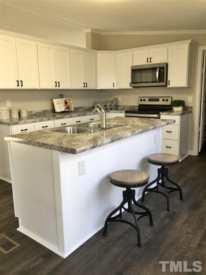 238 Dustin Lane Roxboro, NC 27574 - Photo 10 of 23 a kitchen with stainless steel appliances a stove a sink a stove and a refrigerator