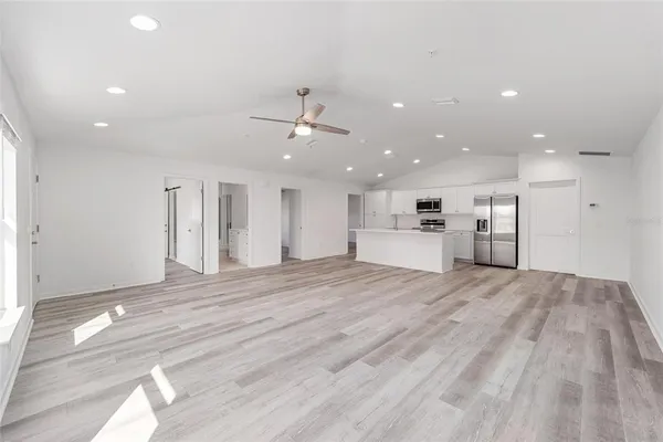 a view of kitchen with kitchen island and stainless steel appliances